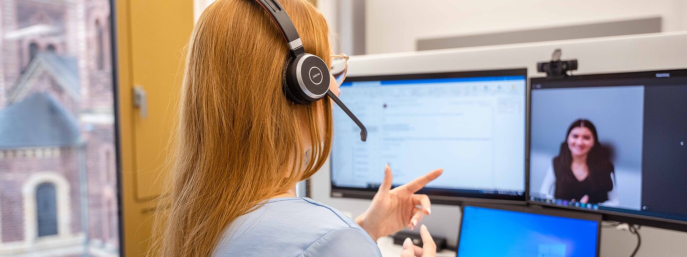 Kollegin im virtuellen Call mit Headset